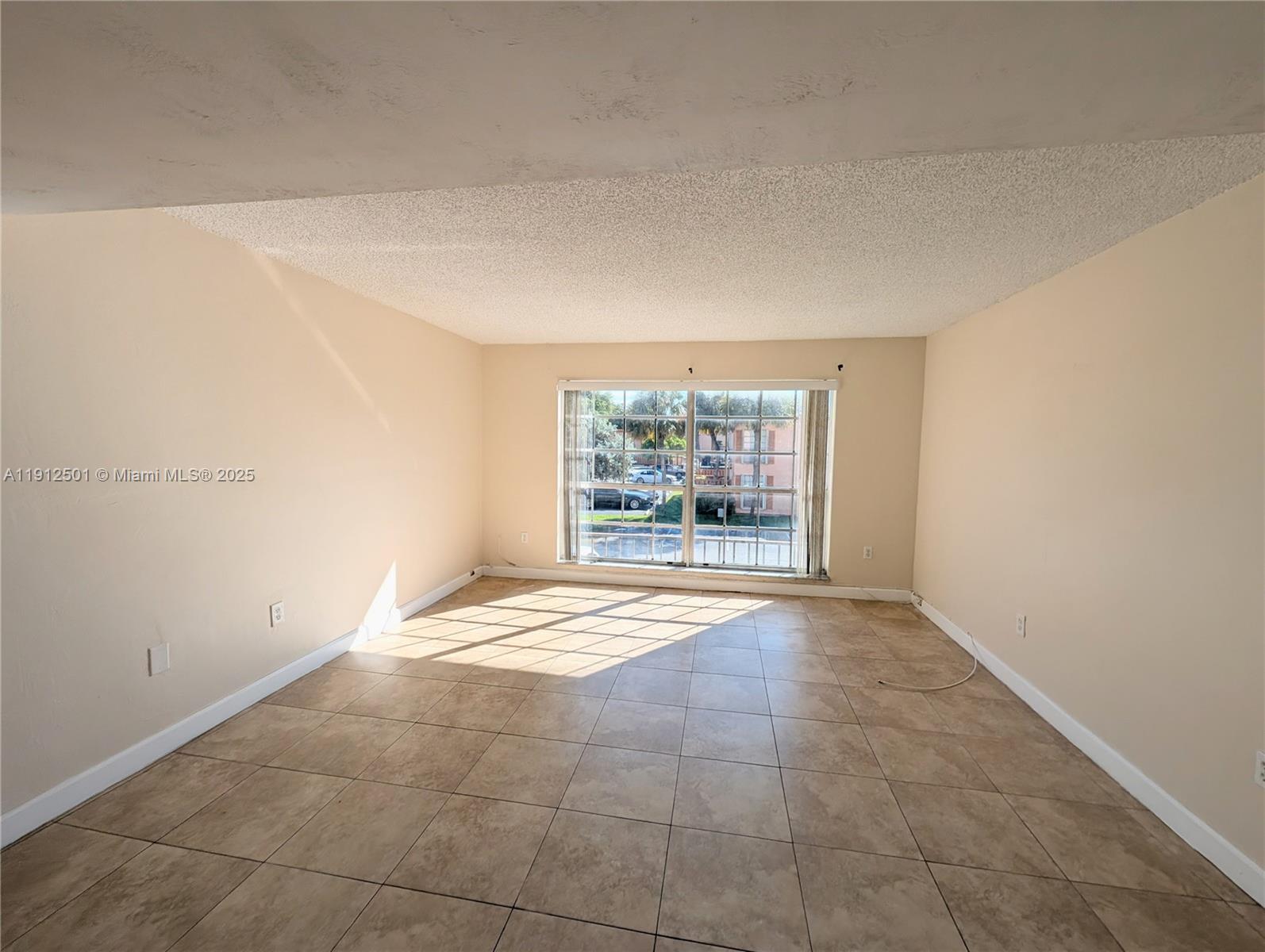 7230 Fairway Drive, Unit F4 Miami Lakes, FL 33014 - Photo 2 of 22 a view of an empty room with a window
