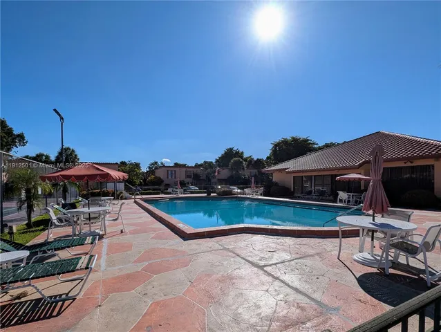 a view of a patio with swimming pool