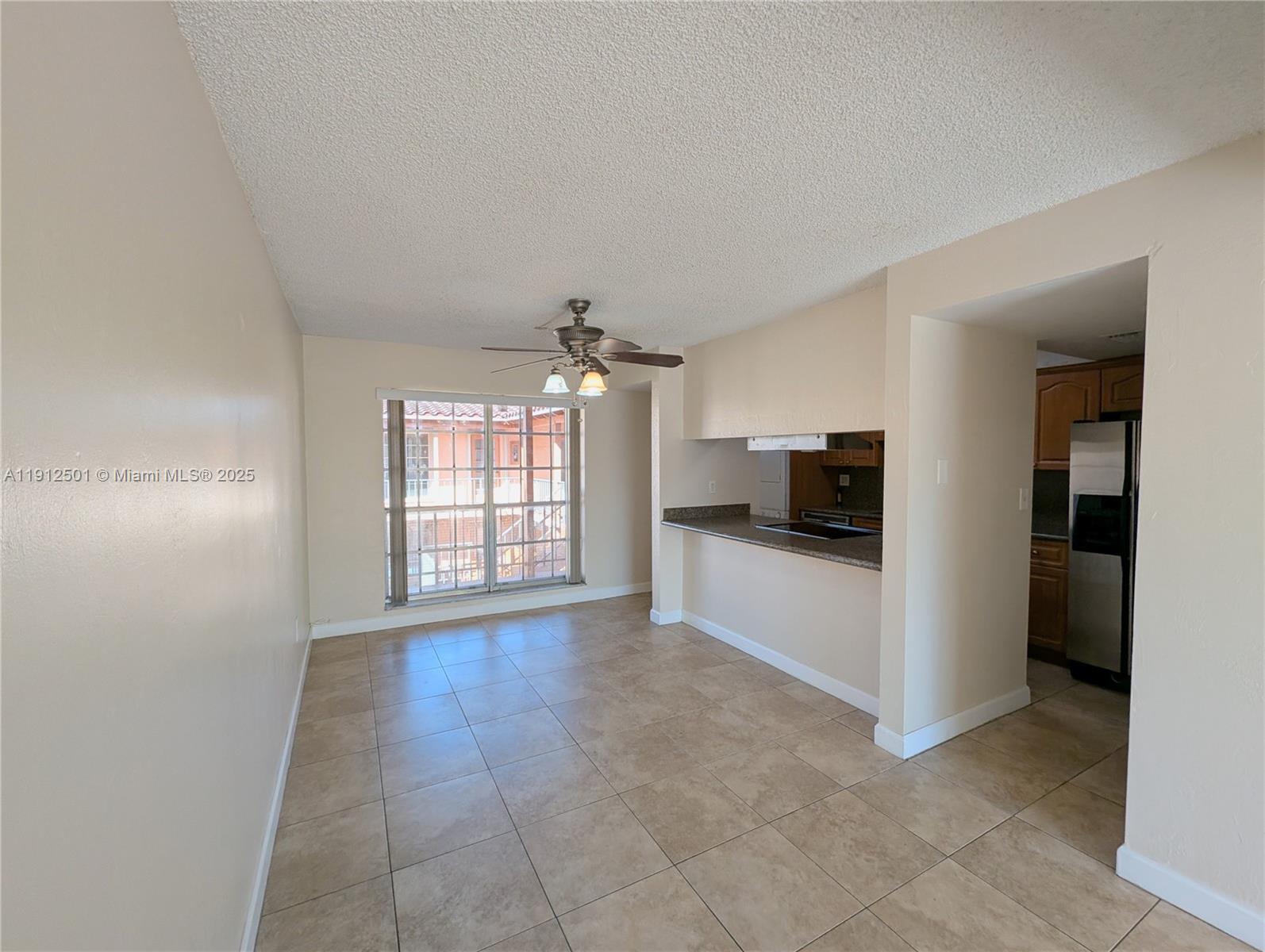 7230 Fairway Drive, Unit F4 Miami Lakes, FL 33014 - Photo 4 of 22 a view of an empty room with kitchen and a window