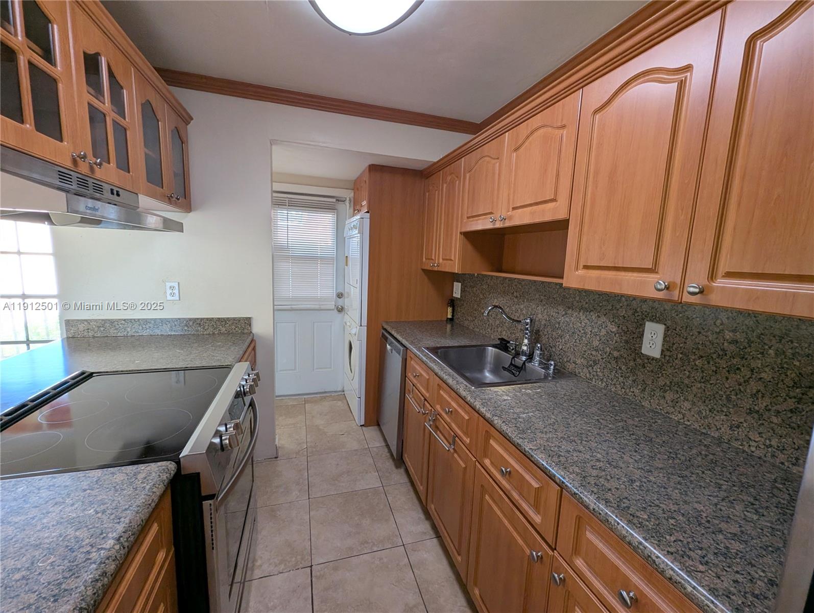 7230 Fairway Drive, Unit F4 Miami Lakes, FL 33014 - Photo 7 of 22 a kitchen with stainless steel appliances granite countertop a sink stove and refrigerator