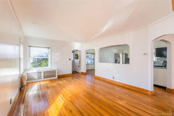 a spacious bedroom with a large bed and a wooden floor