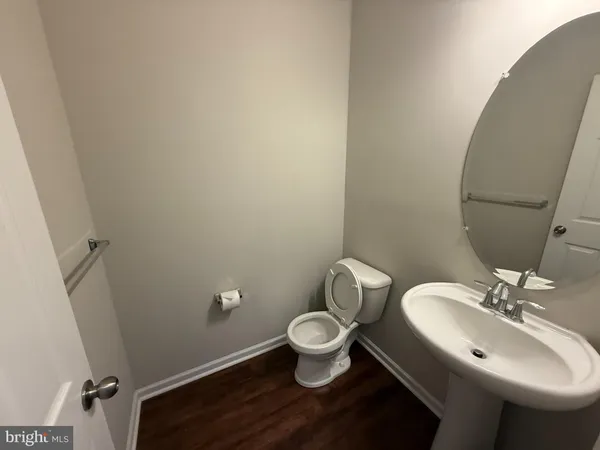 a bathroom with a sink mirror and toilet
