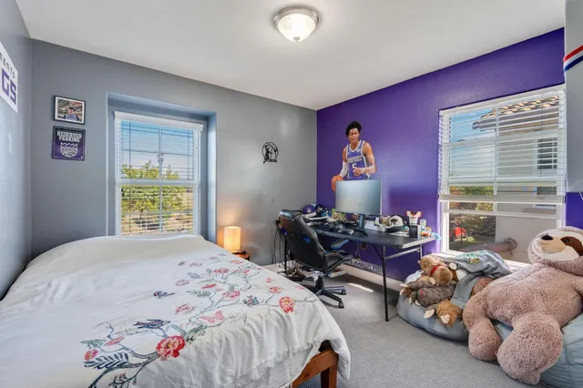 a bedroom with bed and a window