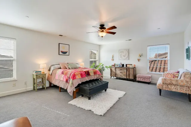 a bedroom with bed and window