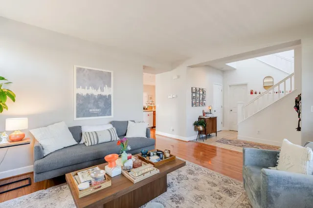 a living room with furniture and wooden floor