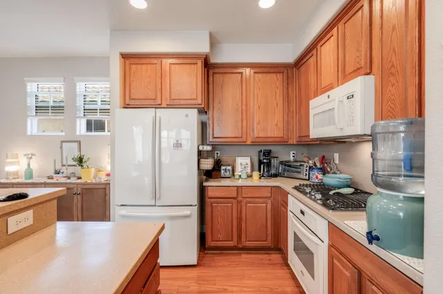 a kitchen with stainless steel appliances granite countertop a refrigerator sink and cabinets