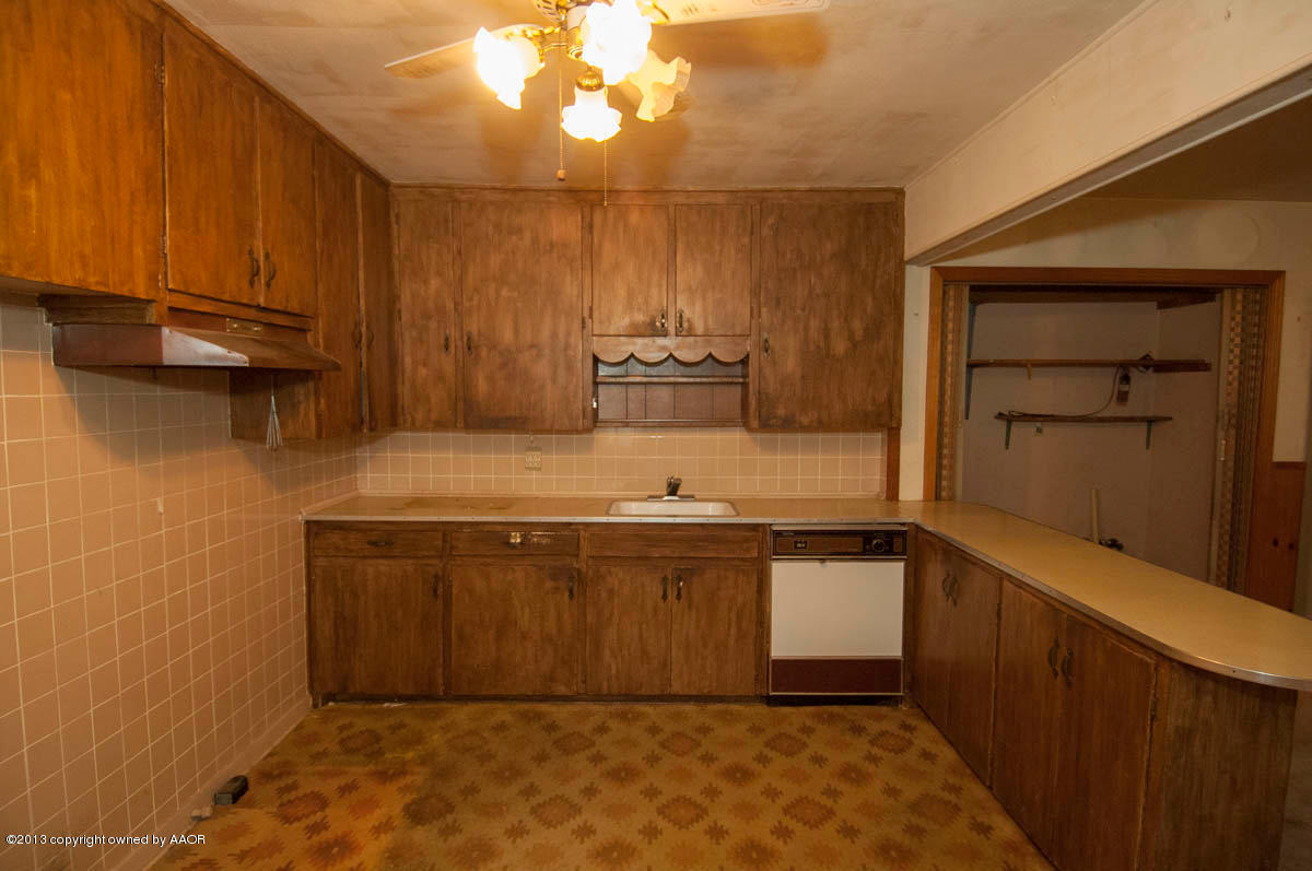 4618 Parker Street Amarillo, TX 79110 - Photo 7 of 19 a bathroom with a granite countertop sink and a mirror