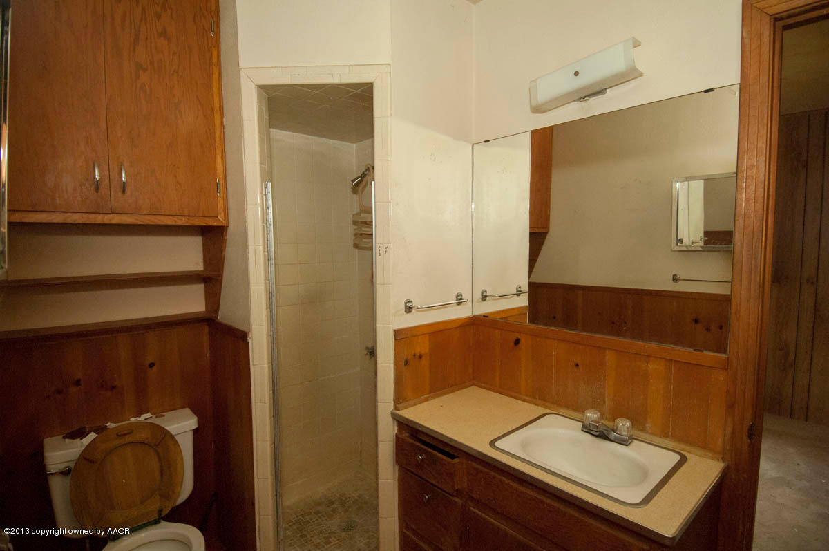 4618 Parker Street Amarillo, TX 79110 - Photo 10 of 19 a bathroom with a sink a toilet and shower