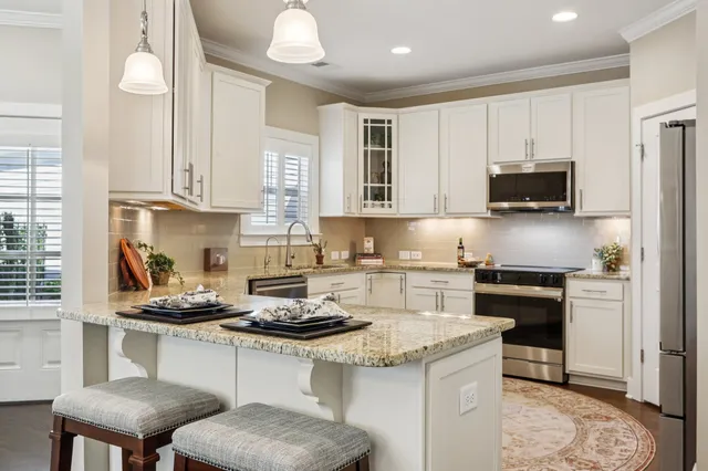 a kitchen with a stove and a white cabinets