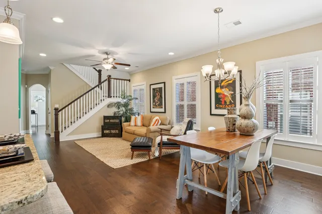 a view of a dining room with furniture wooden floor and chandelier