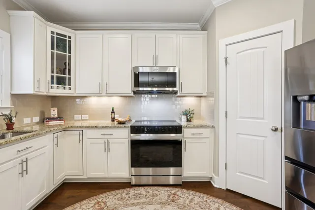 a bedroom with a bed dresser and a chair