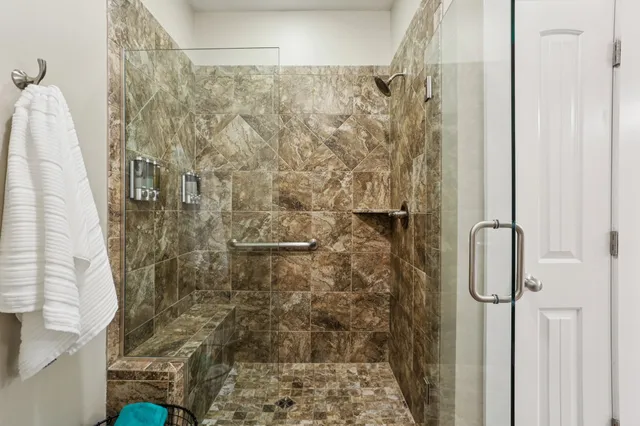 an empty room with a ceiling fan and carpet