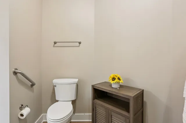 an empty room with chandelier fan