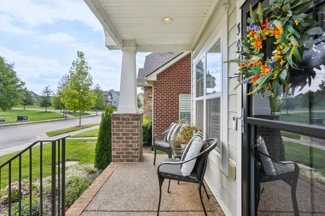 a view of a porch with furniture and a yard