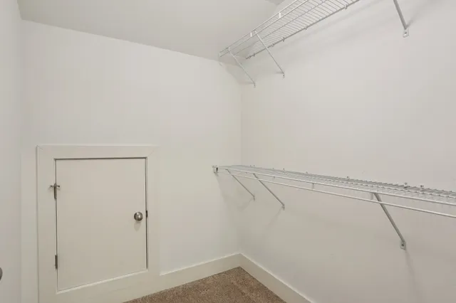 a view of a house with a big yard and palm trees