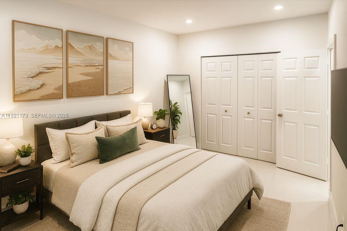 733 Michigan Avenue, Unit 9 Miami Beach, FL 33139 - Photo 8 of 13 a bedroom with a bed and a window