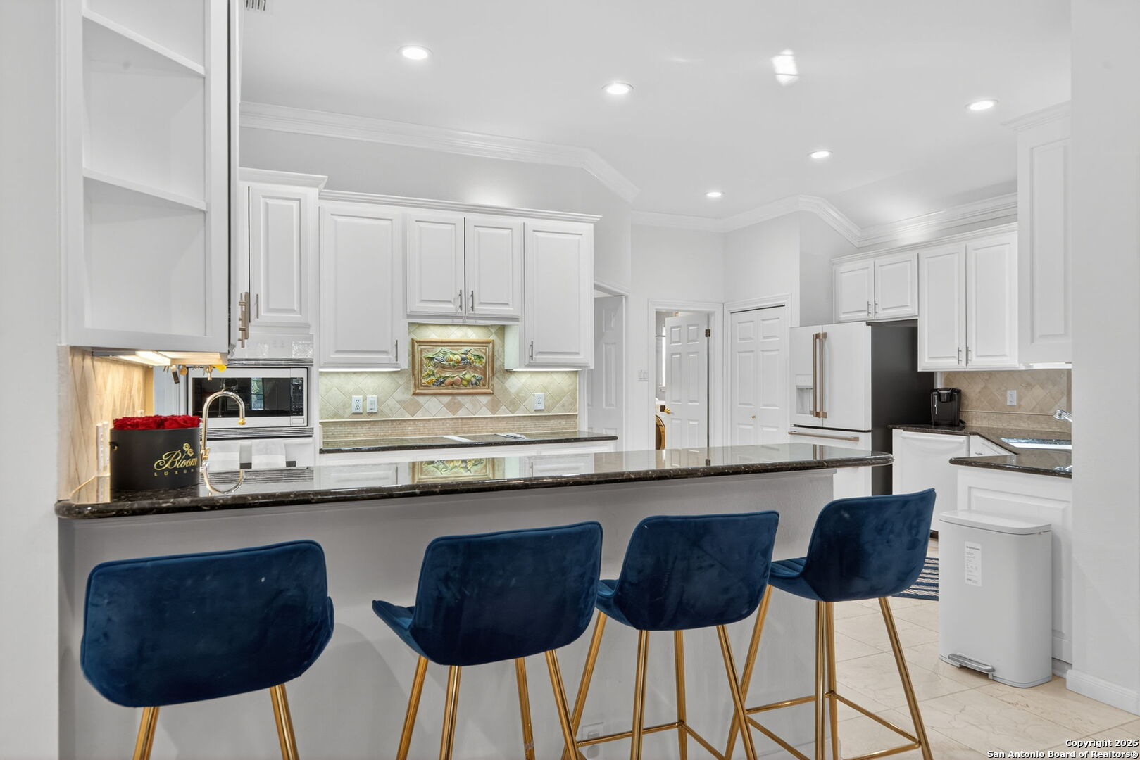 6 Regent Arms San Antonio, TX 78257 - Photo 13 of 29 a kitchen with stainless steel appliances granite countertop a sink a stove a refrigerator cabinets and chairs