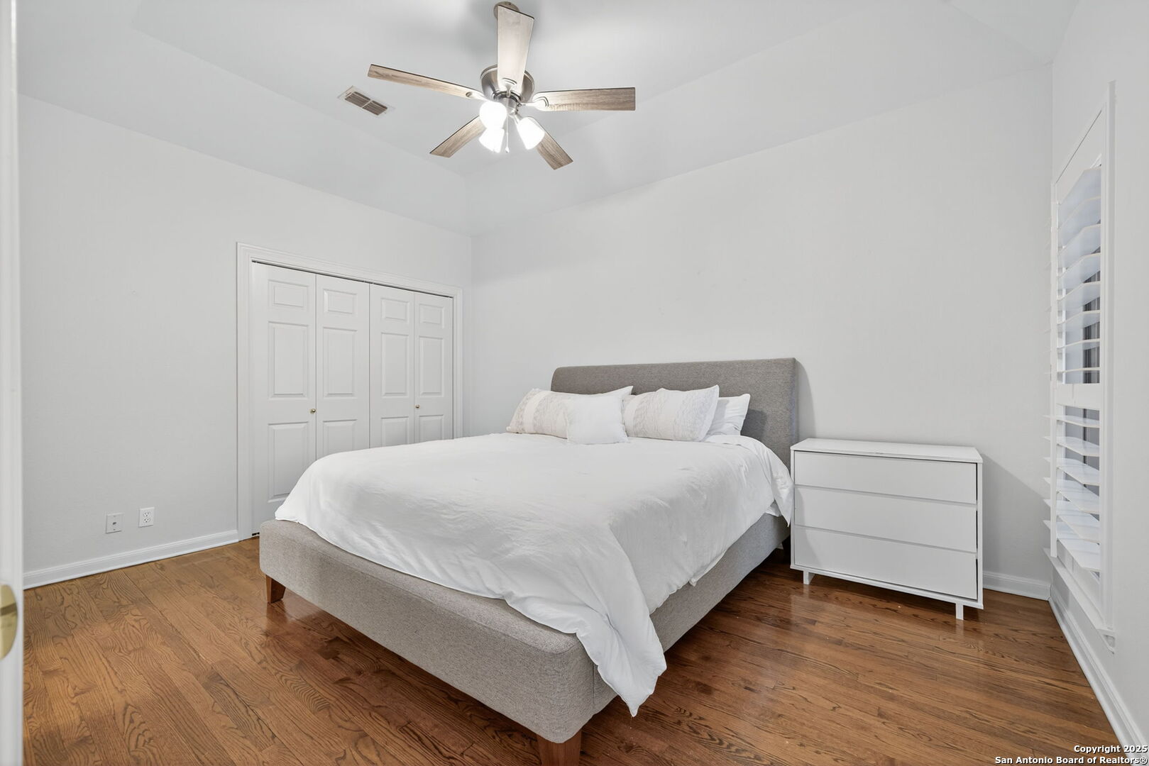 6 Regent Arms San Antonio, TX 78257 - Photo 19 of 29 a bedroom with a bed and a chandelier