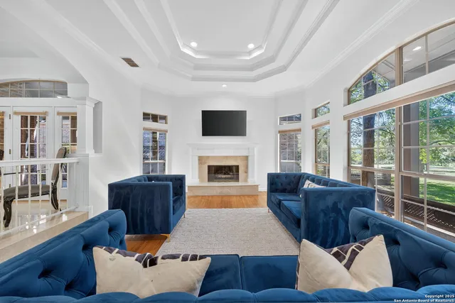 a living room with furniture fireplace and flat screen tv