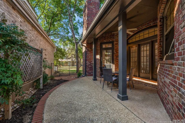 a view of a porch with wooden stairs and a bench