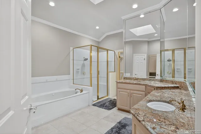 a spacious bathroom with a granite countertop tub sink and mirror