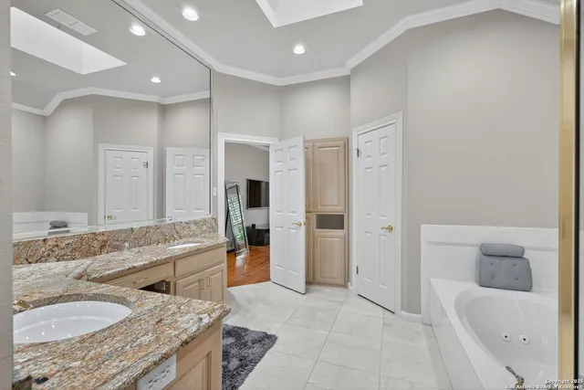 a bathroom with a granite countertop sink a toilet and shower