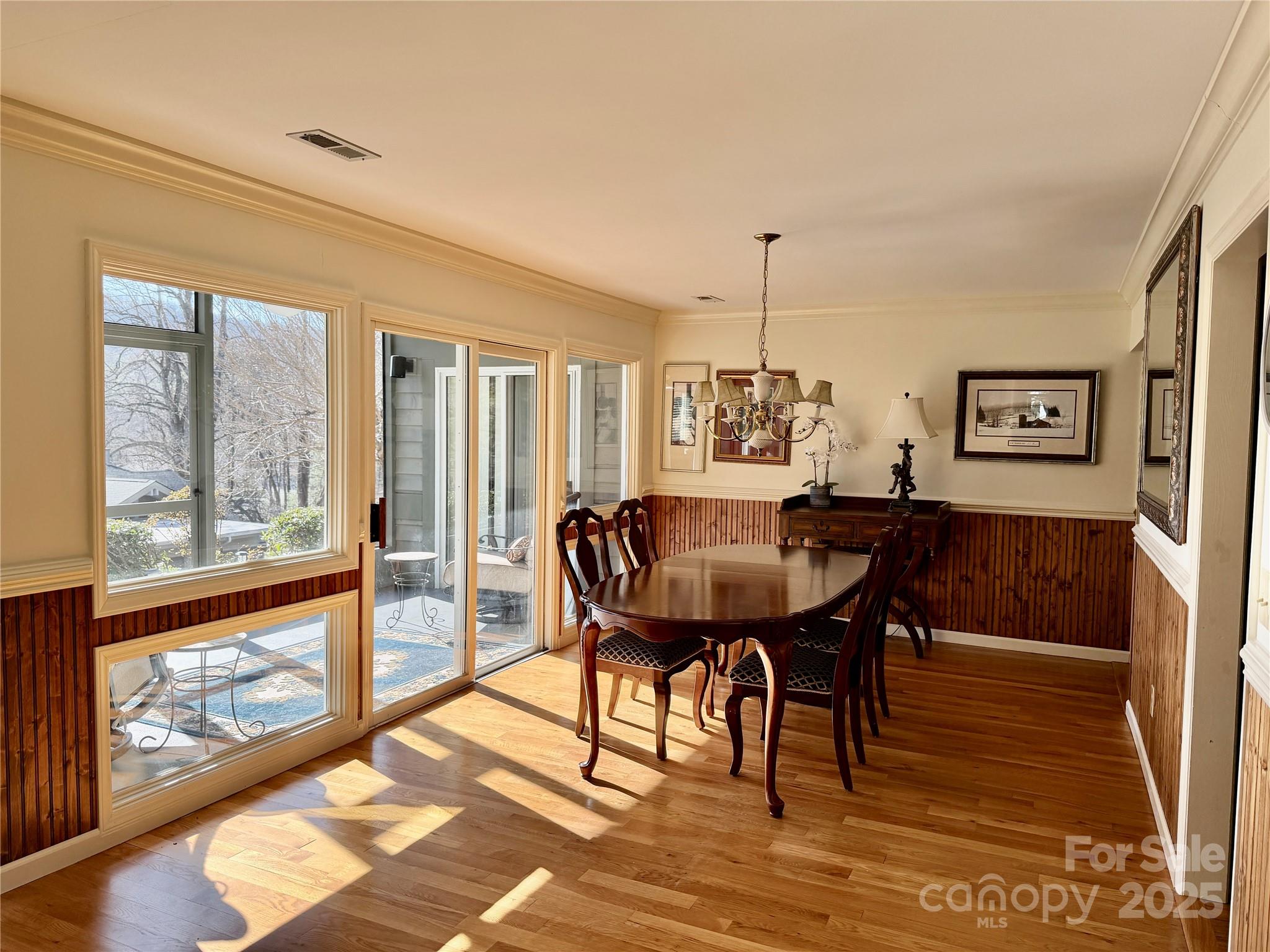111 Burning Tree Lane, Unit C601 Flat Rock, NC 28731 - Photo 9 of 32 a view of a dining room with furniture window and wooden floor
