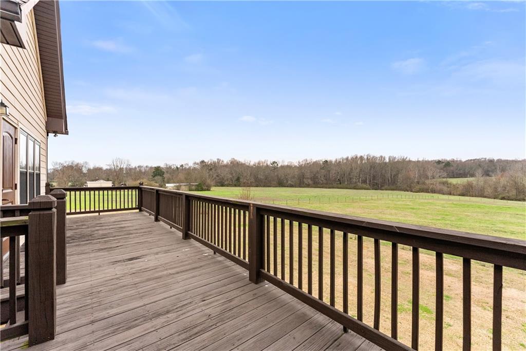725 County Farm Road Jefferson, GA 30549 - Photo 48 of 66 a view of a balcony with wooden floor and fence