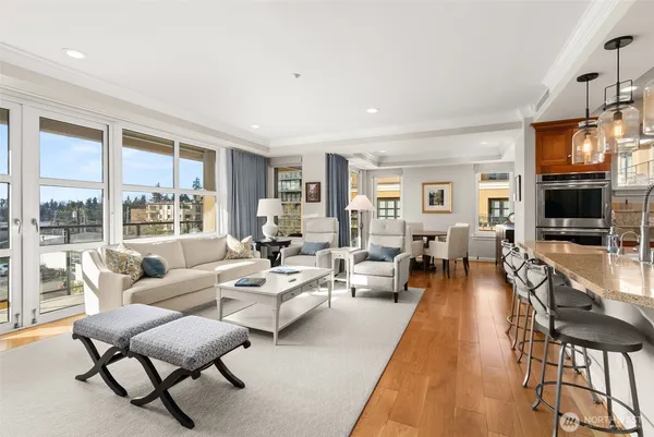 a living room with furniture wooden floor and a flat screen tv