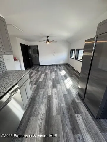 a view of empty room with wooden floor