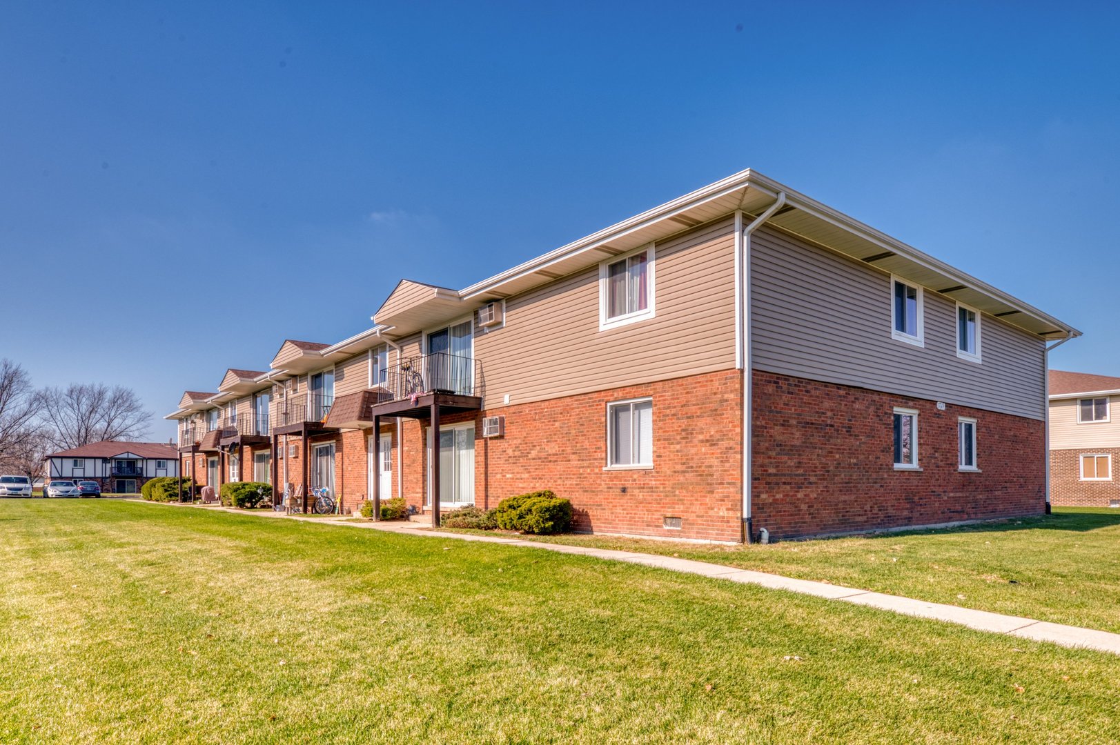 1713 Nelson Road, Unit 2 New Lenox, IL 60451 - Photo 2 of 10 a backyard of a house with wooden fence and large trees