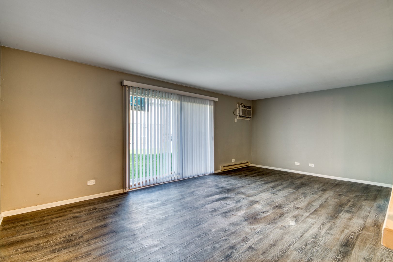 1713 Nelson Road, Unit 2 New Lenox, IL 60451 - Photo 4 of 10 an empty room with wooden floor and windows