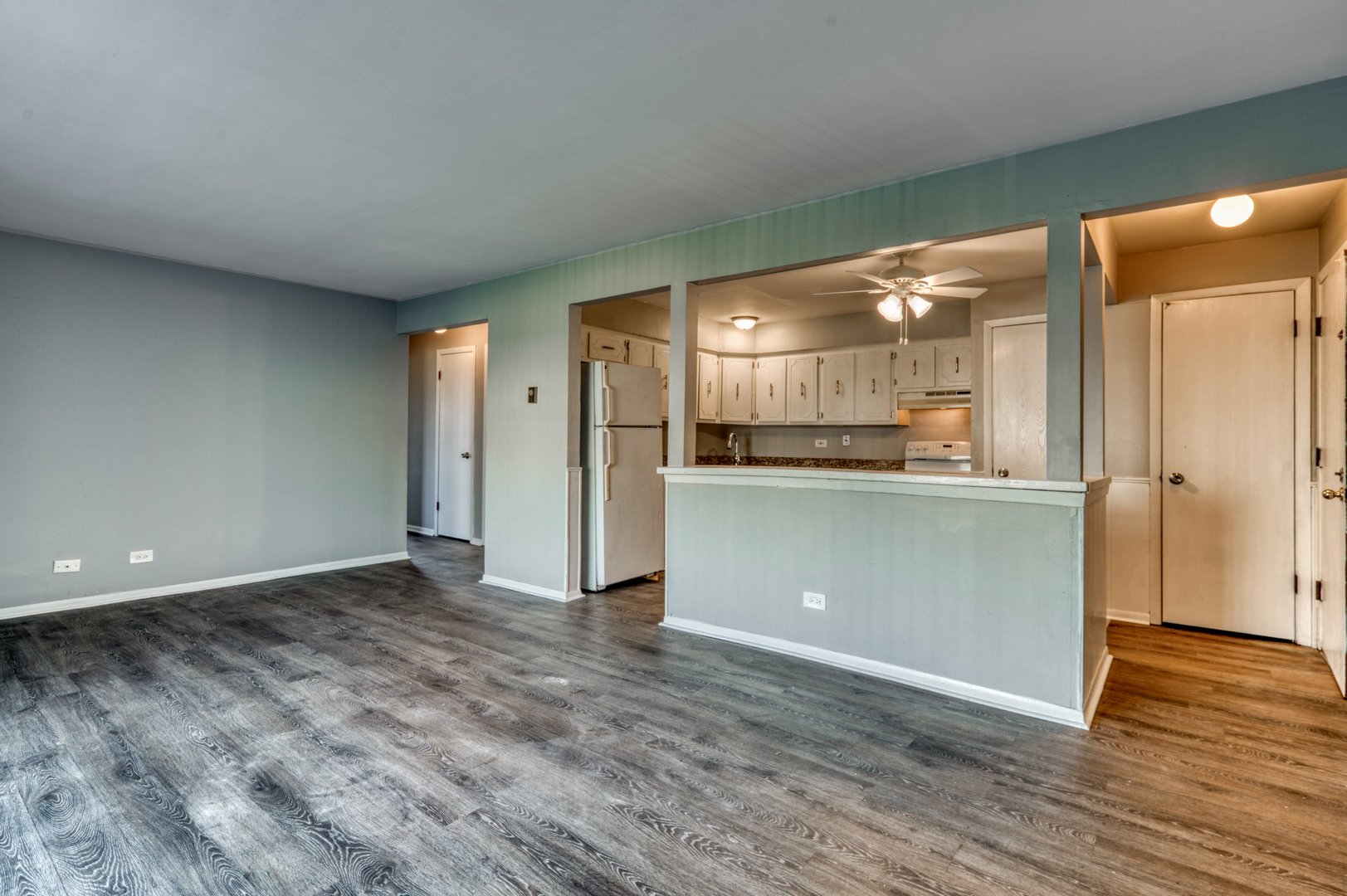 1713 Nelson Road, Unit 2 New Lenox, IL 60451 - Photo 5 of 10 a view of a kitchen with a fridge and wooden floor