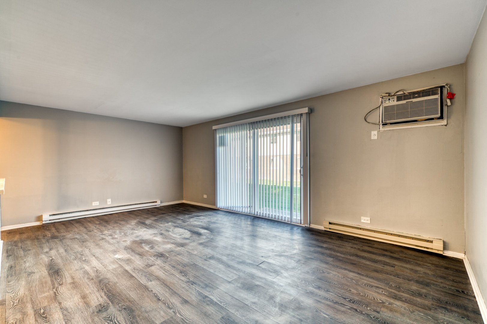 1713 Nelson Road, Unit 2 New Lenox, IL 60451 - Photo 7 of 10 an empty room with wooden floor and windows