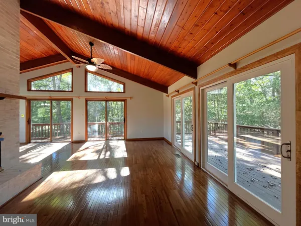 a view of balcony with wooden floor and fence