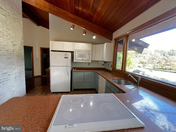 a view of a kitchen with a stove cabinets and a large window