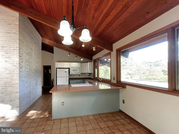 a kitchen with a sink window and stainless steel appliances
