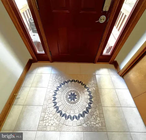 a view of empty room with wooden floor and fireplace