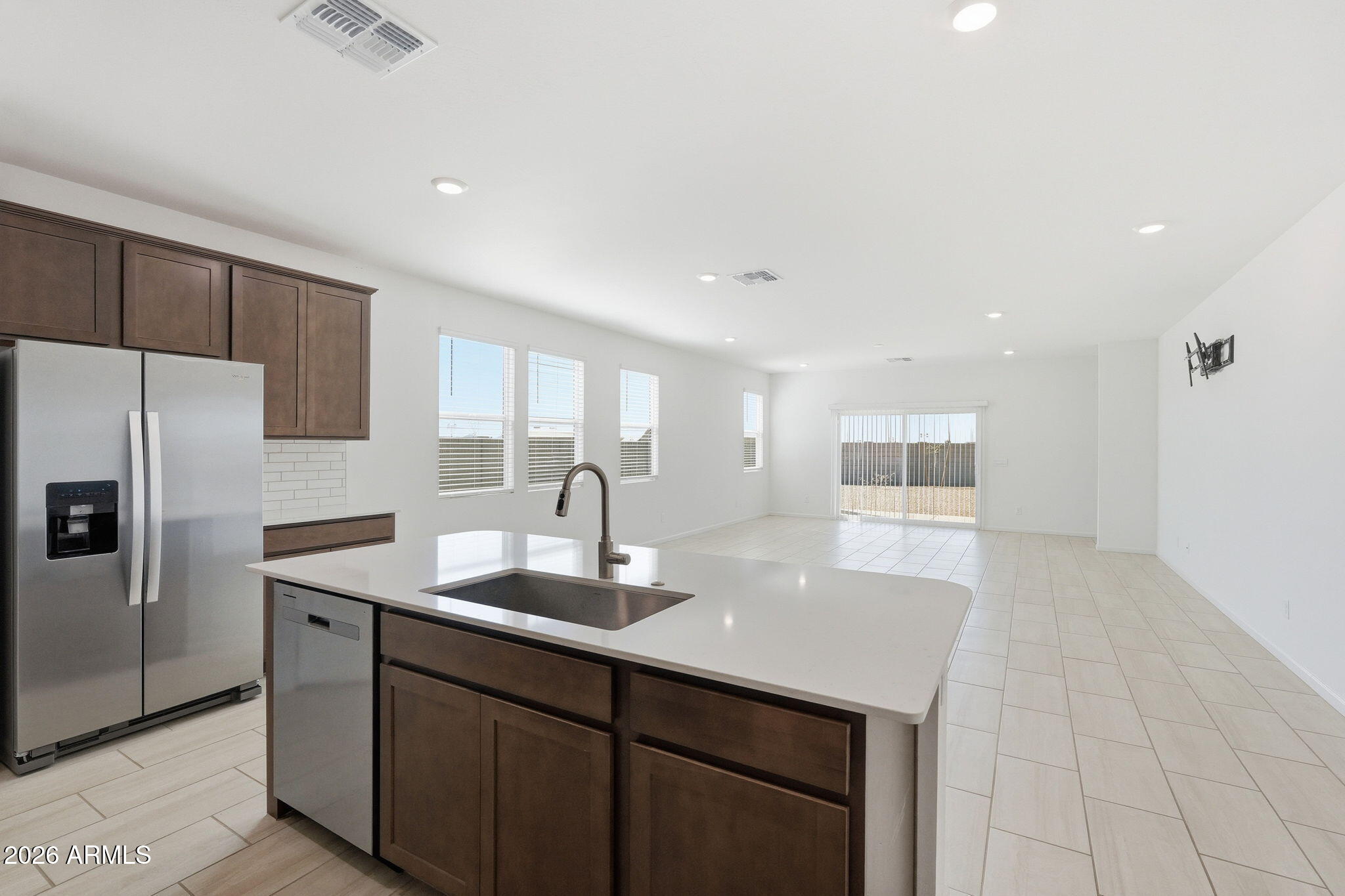 25489 West Fraktur Road Buckeye, AZ 85326 - Photo 11 of 39 a kitchen with kitchen island a sink appliances and cabinets