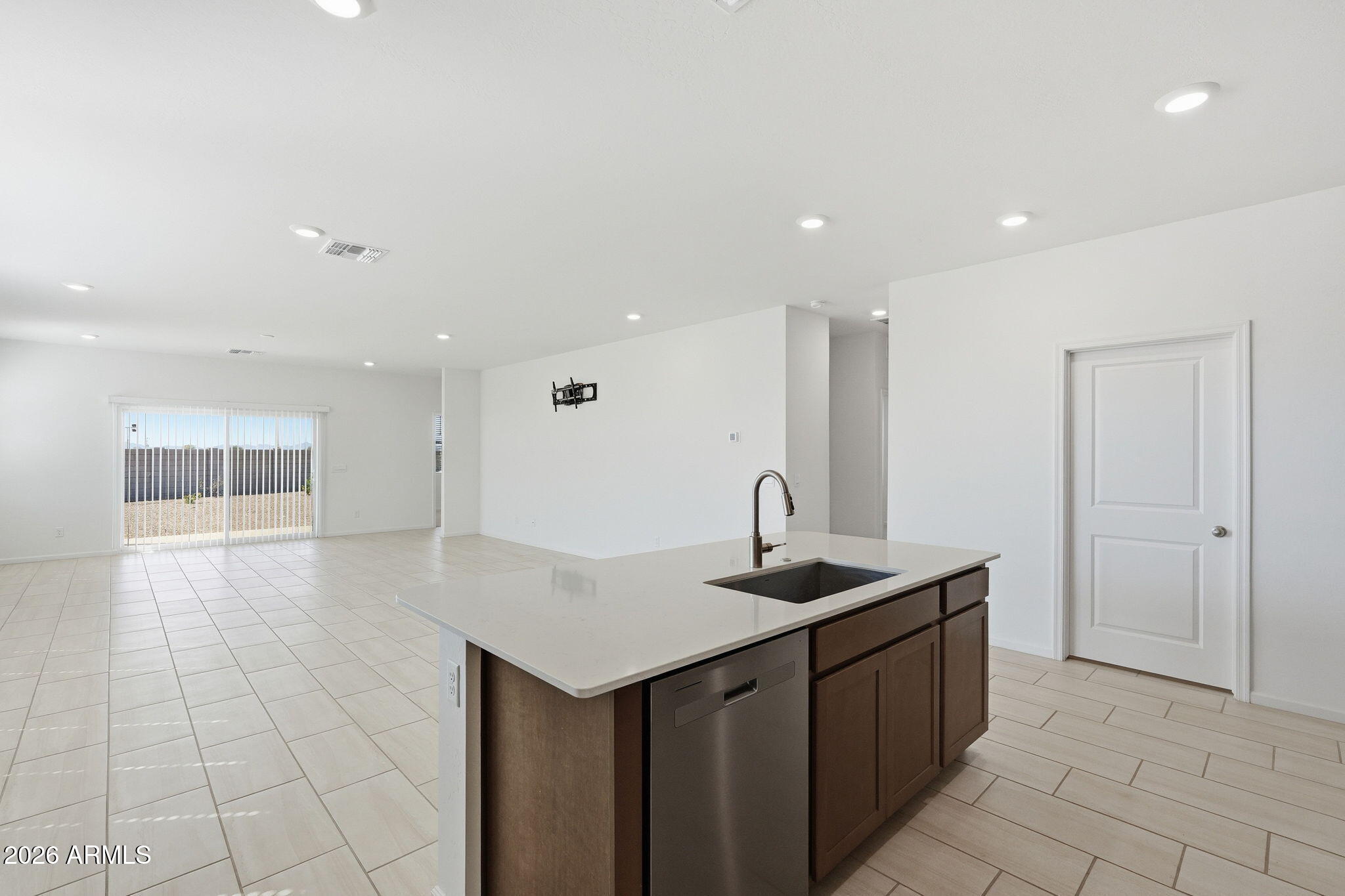 25489 West Fraktur Road Buckeye, AZ 85326 - Photo 15 of 39 a kitchen with stainless steel appliances granite countertop a sink and a white cabinets