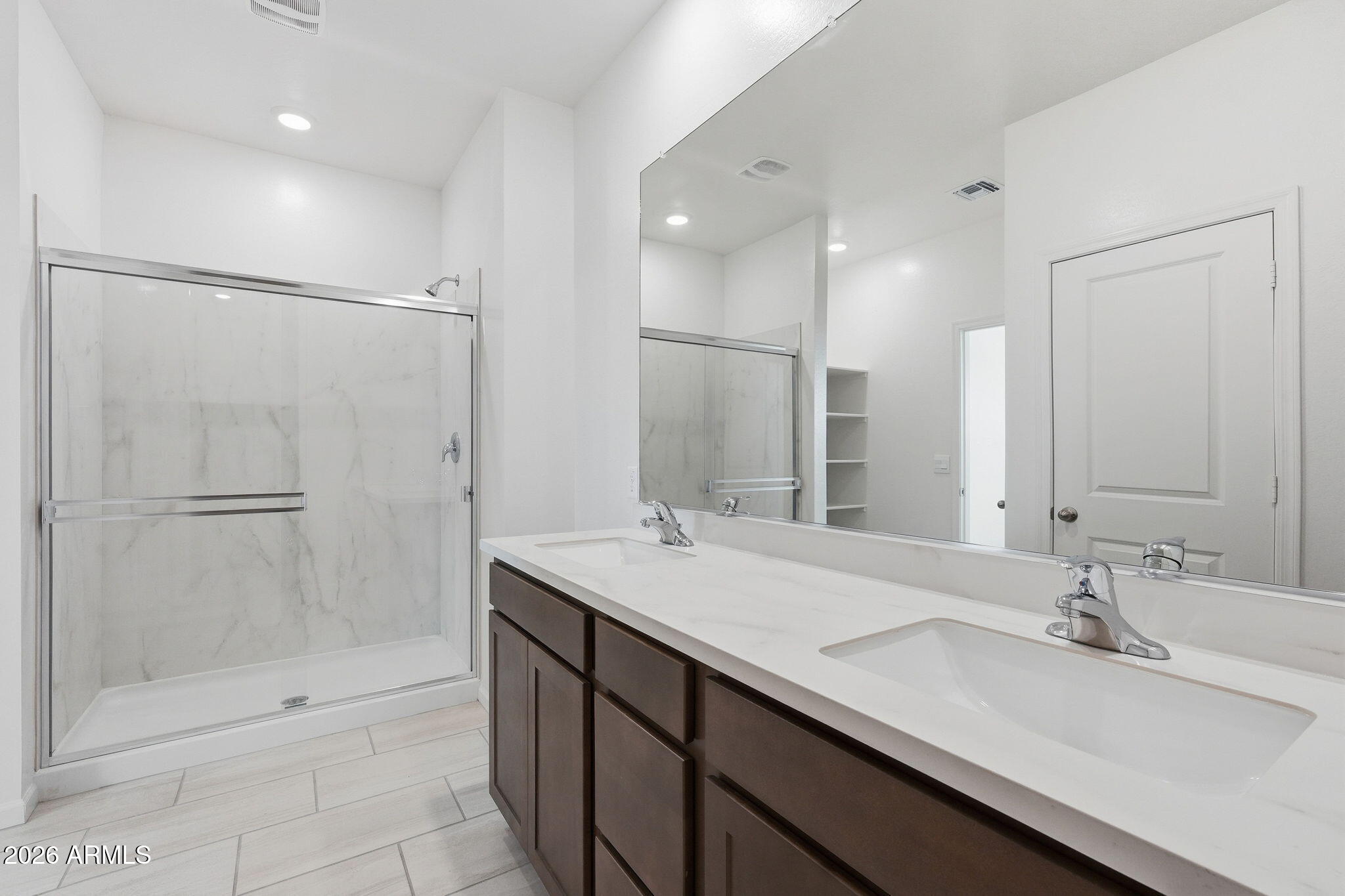25489 West Fraktur Road Buckeye, AZ 85326 - Photo 25 of 39 a bathroom with a double vanity sink mirror and shower