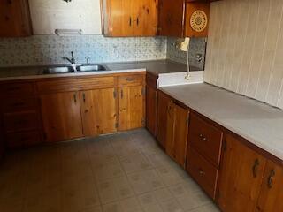 1313 26th Street Lubbock, TX 79411 - Photo 4 of 11 a kitchen with a sink and cabinets