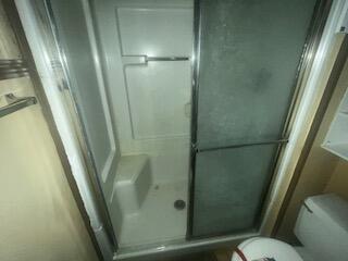 1313 26th Street Lubbock, TX 79411 - Photo 8 of 11 a bathroom with a shower and toilet