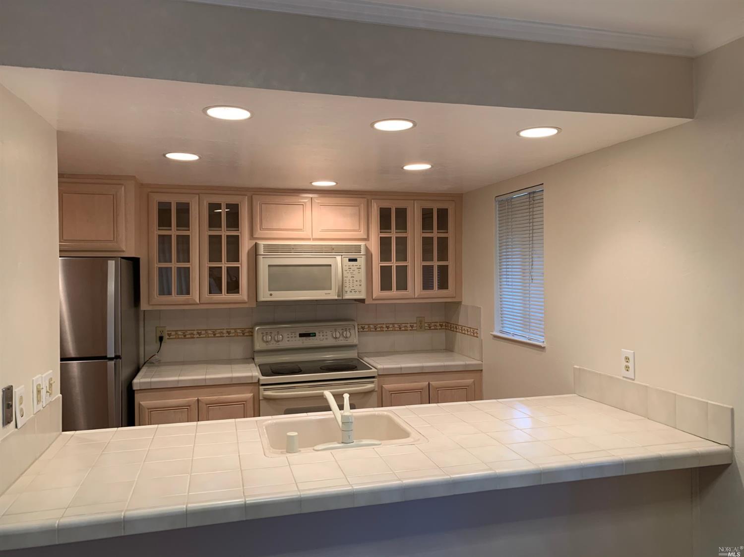 a kitchen with stainless steel appliances a refrigerator and a sink