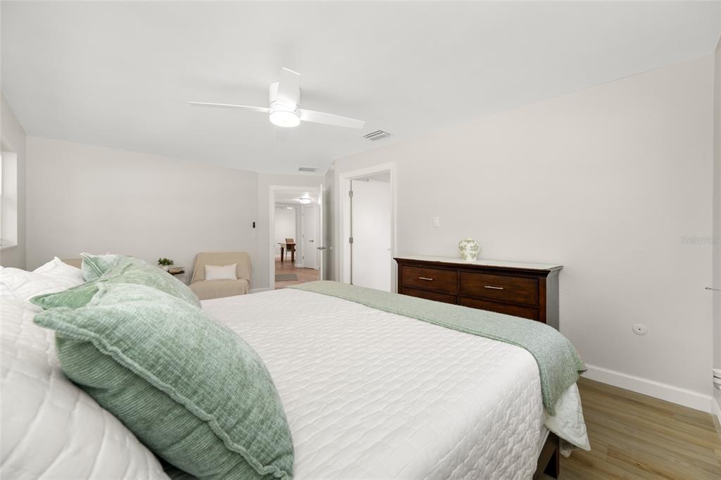 656 Mehlenbacher Road Belleair, FL 33756 - Photo 25 of 49 a bedroom with a bed and a chandelier