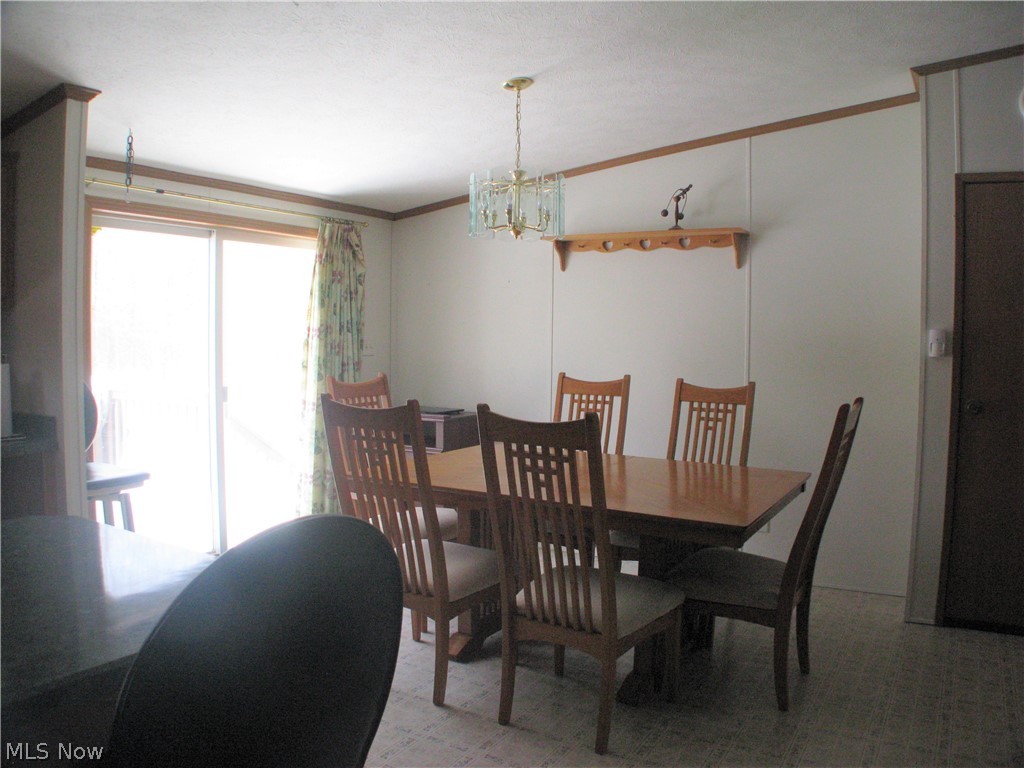 7963 Fenton Road Orwell, OH 44076 - Photo 7 of 20 Dining table in kitchen with patio doors out to deck overlooking back yard