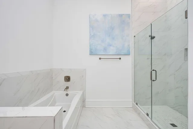 a bathroom with a bathtub and a shower