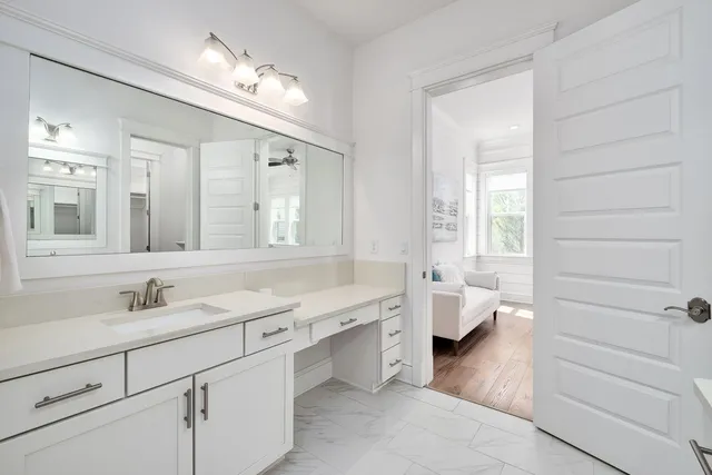 a bathroom with a double vanity sink mirror and bathtub