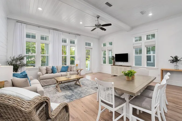 a living room with furniture and flat screen tv