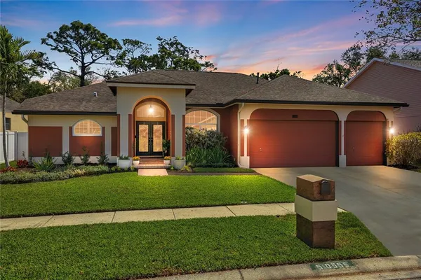 a front view of a house with a garden